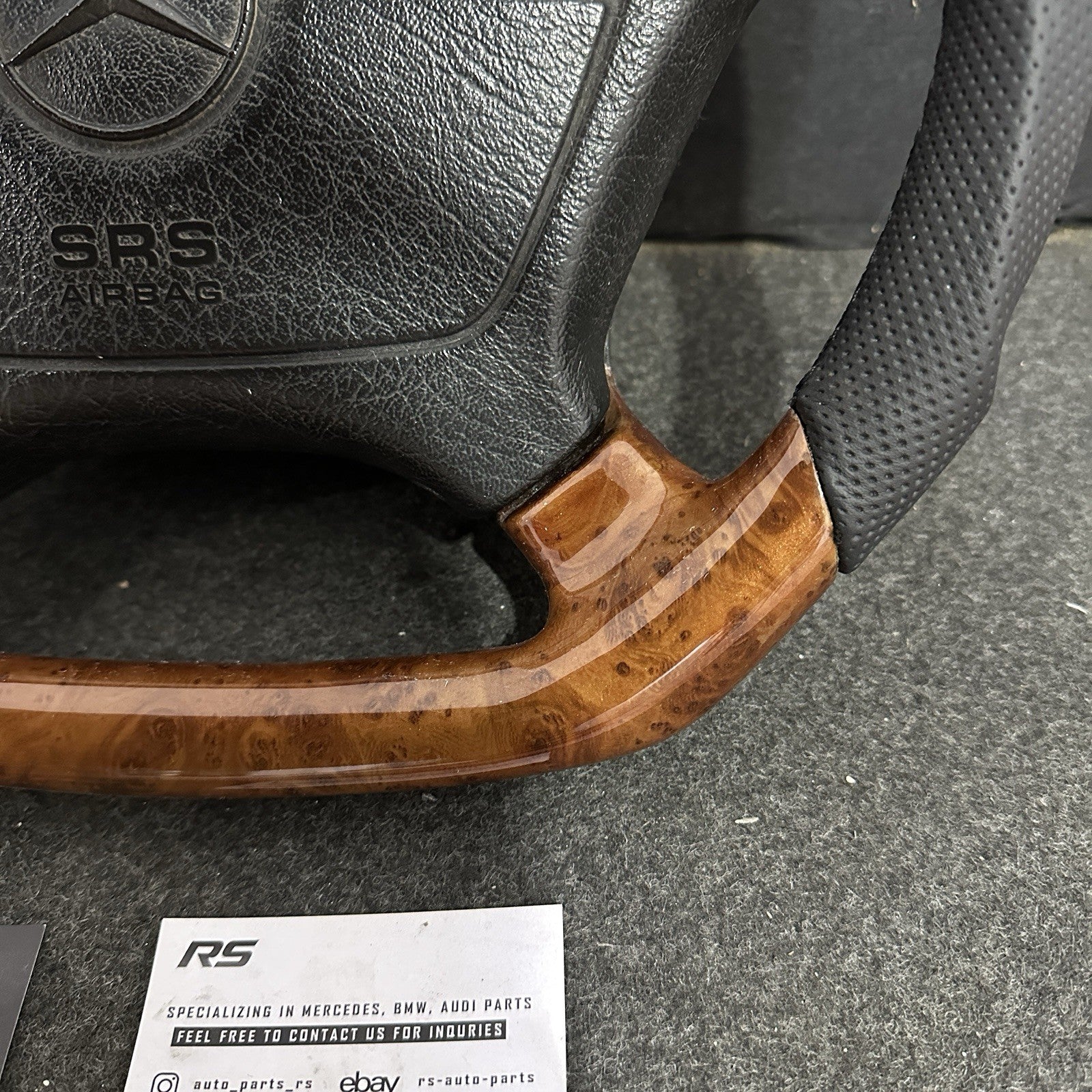 Deep-grain Burl Wood finish on a custom Mercedes-Benz steering wheel, professionally clear-coated for a high-gloss, durable mirror reflection.