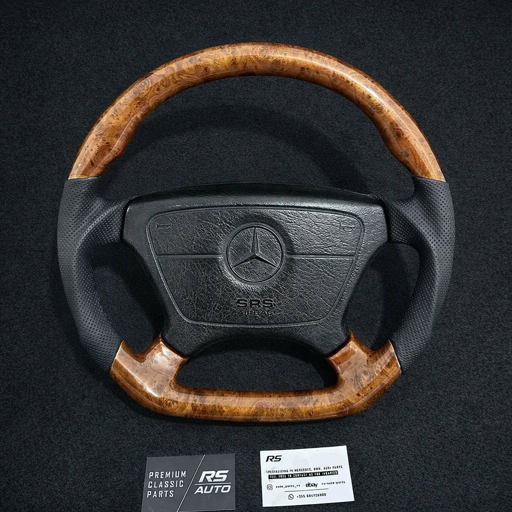 Custom Mercedes-Benz airbag steering wheel with burl walnut top and flat-bottom sections and black perforated leather grips